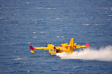 Image showing Airplane on sea taking water