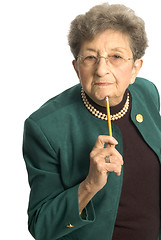 Image showing senior woman with pencil