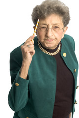 Image showing senior woman with pencil