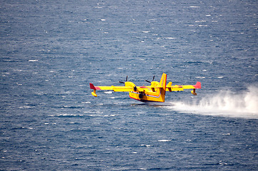 Image showing Airplane on sea taking water