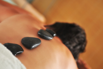 Image showing beautiful woman have hotstone massage at spa and wellness center