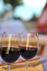 Image showing two glasses in outside restaurant with black wine