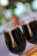 Image showing two glasses in outside restaurant with black wine