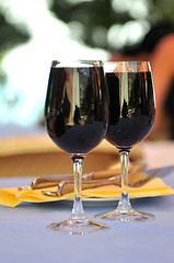 Image showing two glasses in outside restaurant with black wine