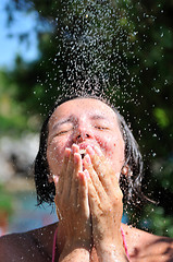 Image showing young pretty woman relaxing under shower