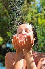 Image showing young pretty woman relaxing under shower