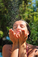 Image showing young pretty woman relaxing under shower