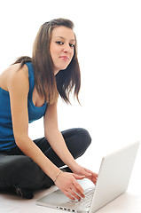 Image showing one young girl work on laptop isolated on white