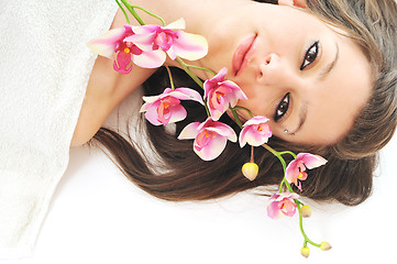 Image showing beautiful young  woman face with flower and towel