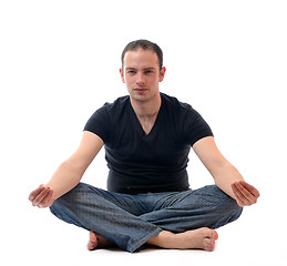 Image showing young man in lotus position exercising yoga