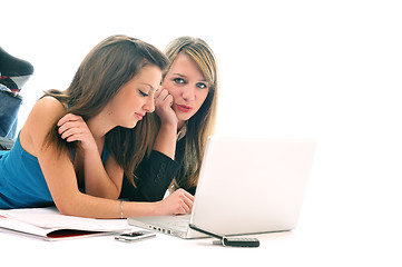 Image showing two young girls work on laptop isolated