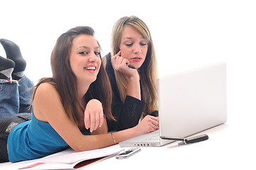 Image showing two young girls work on laptop isolated