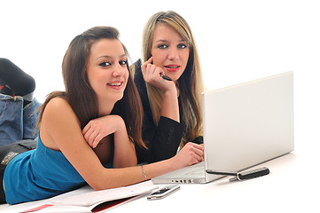 Image showing two young girls work on laptop isolated