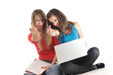 Image showing two young girls work on laptop isolated