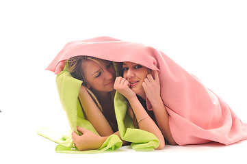 Image showing young girls under blanket smile