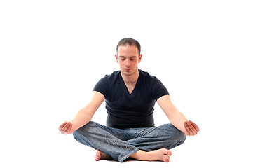 Image showing young man in lotus position exercising yoga