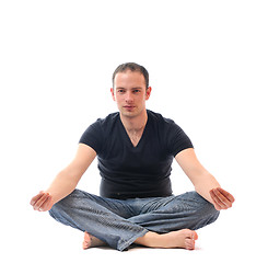 Image showing young man in lotus position exercising yoga