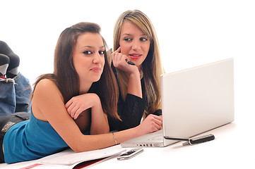 Image showing two young girls work on laptop isolated