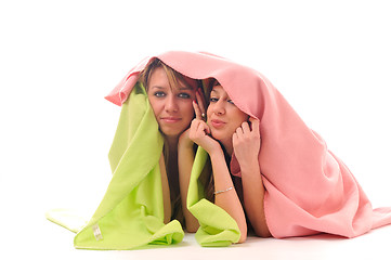 Image showing young girls under blanket smile 