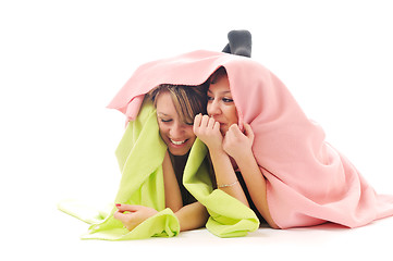 Image showing young girls under blanket smile