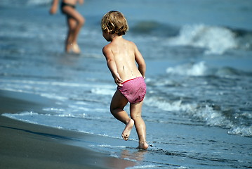 Image showing little girl running at the beach