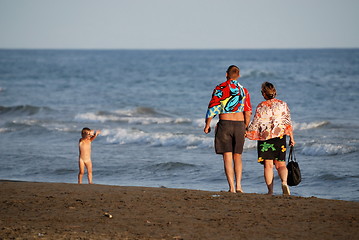 Image showing young family relaxing on beach