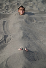 Image showing happy children buried in sand