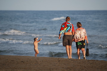 Image showing young family relaxing on beach