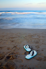 Image showing sandals on beach with long exposure