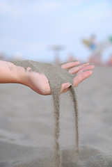 Image showing fine sand leaking trought woman hands