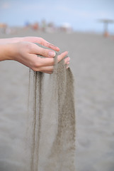 Image showing fine sand leaking trought woman hands
