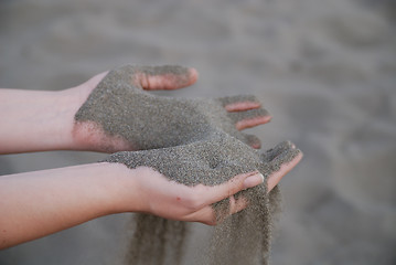 Image showing fine sand leaking trought woman hands