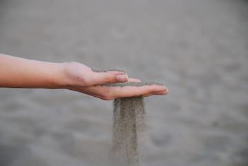 Image showing fine sand leaking trought woman hands