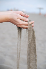 Image showing fine sand leaking trought woman hands