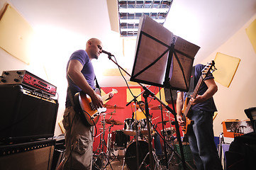 Image showing music band have training in garage