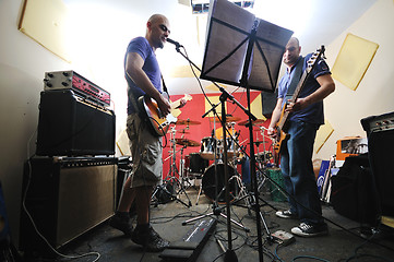 Image showing music band have training in garage