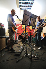 Image showing music band have training in garage