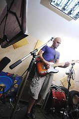 Image showing music band have training in garage