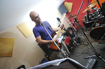 Image showing music band have training in garage