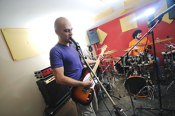 Image showing music band have training in garage