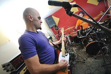 Image showing music band have training in garage