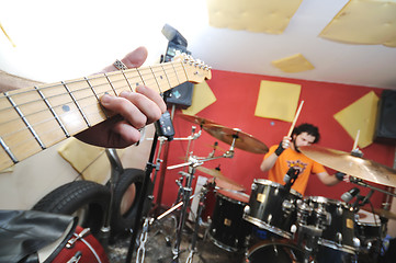 Image showing music band have training in garage