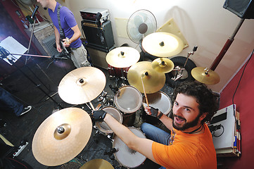 Image showing music band have training in garage