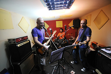 Image showing music band have training in garage