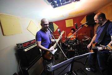 Image showing music band have training in garage