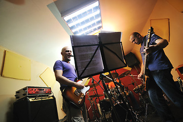 Image showing music band have training in garage