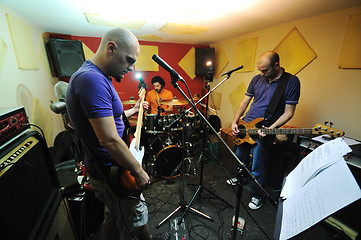 Image showing music band have training in garage