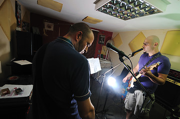 Image showing music band have training in garage
