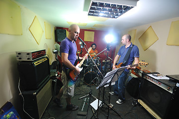 Image showing music band have training in garage