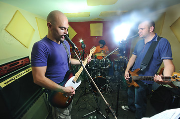 Image showing music band have training in garage